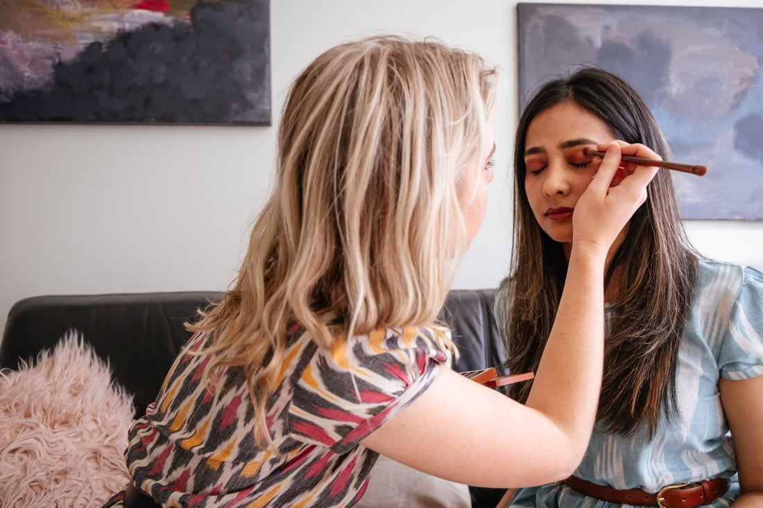 Professional makeup artist applying makeup on a model — makeup classes and beauty training at Bela Beauty College