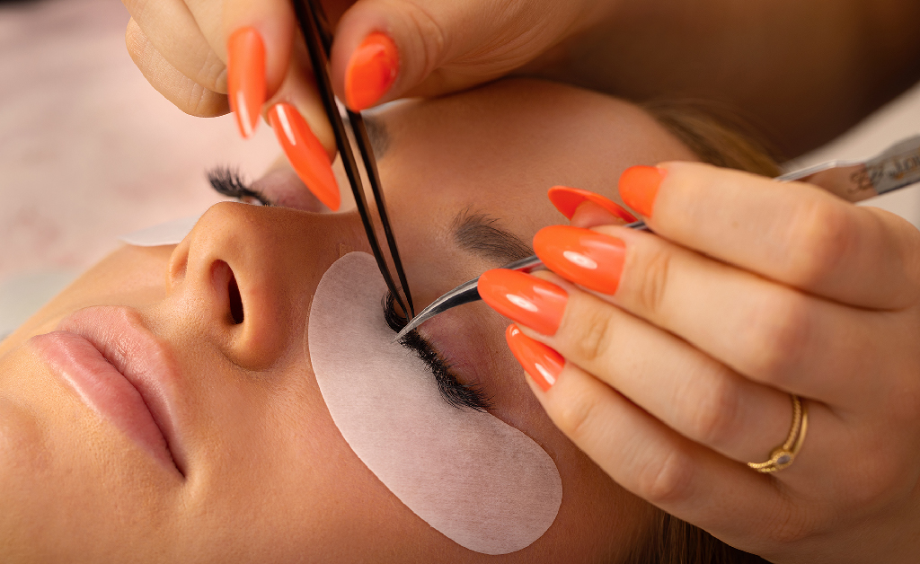 Detailed view of lash extension application process.